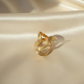 Vergoldete Ohrringe mit geschwungener, wellenartiger Form und strukturierter Oberfläche – modernes, elegantes Design aus Edelstahl von LOÉAR.