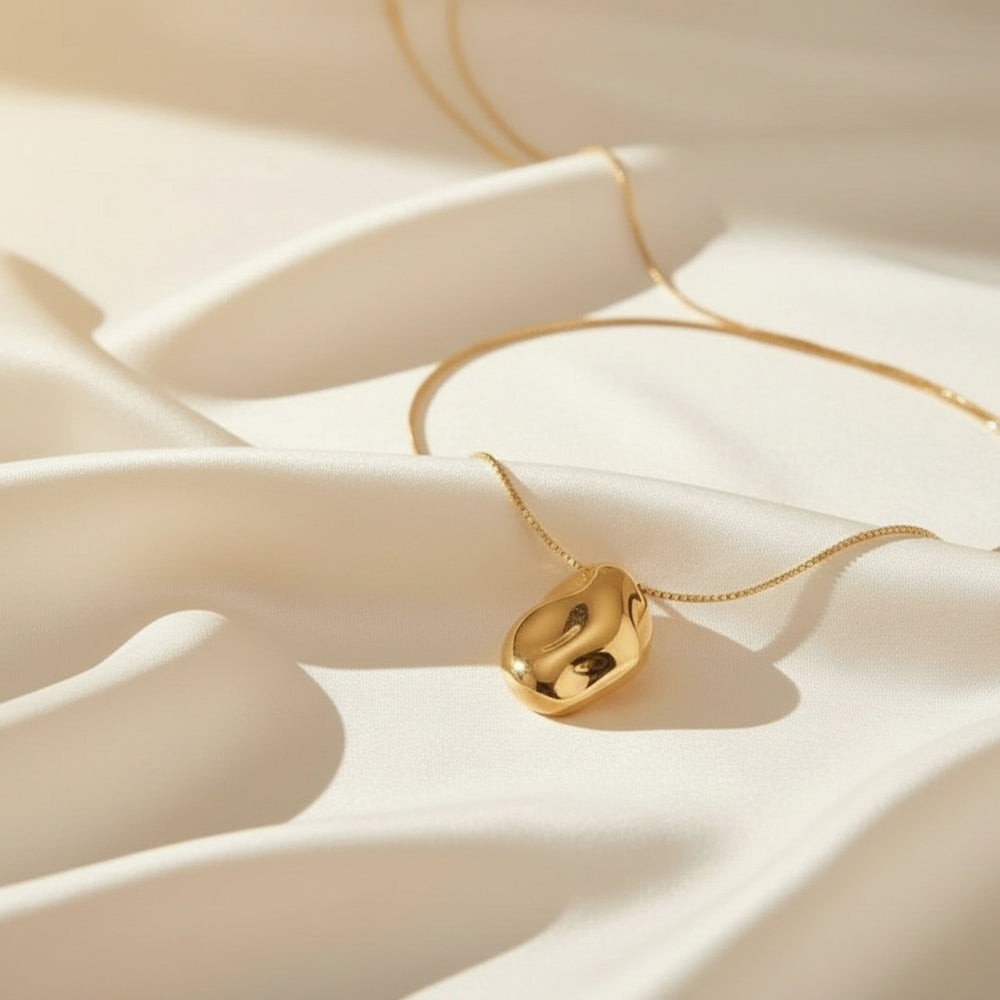 Vergoldete Halskette mit skulpturalem, fließend geformtem Anhänger – modernes, minimalistisches Design aus Edelstahl von LOÉAR.